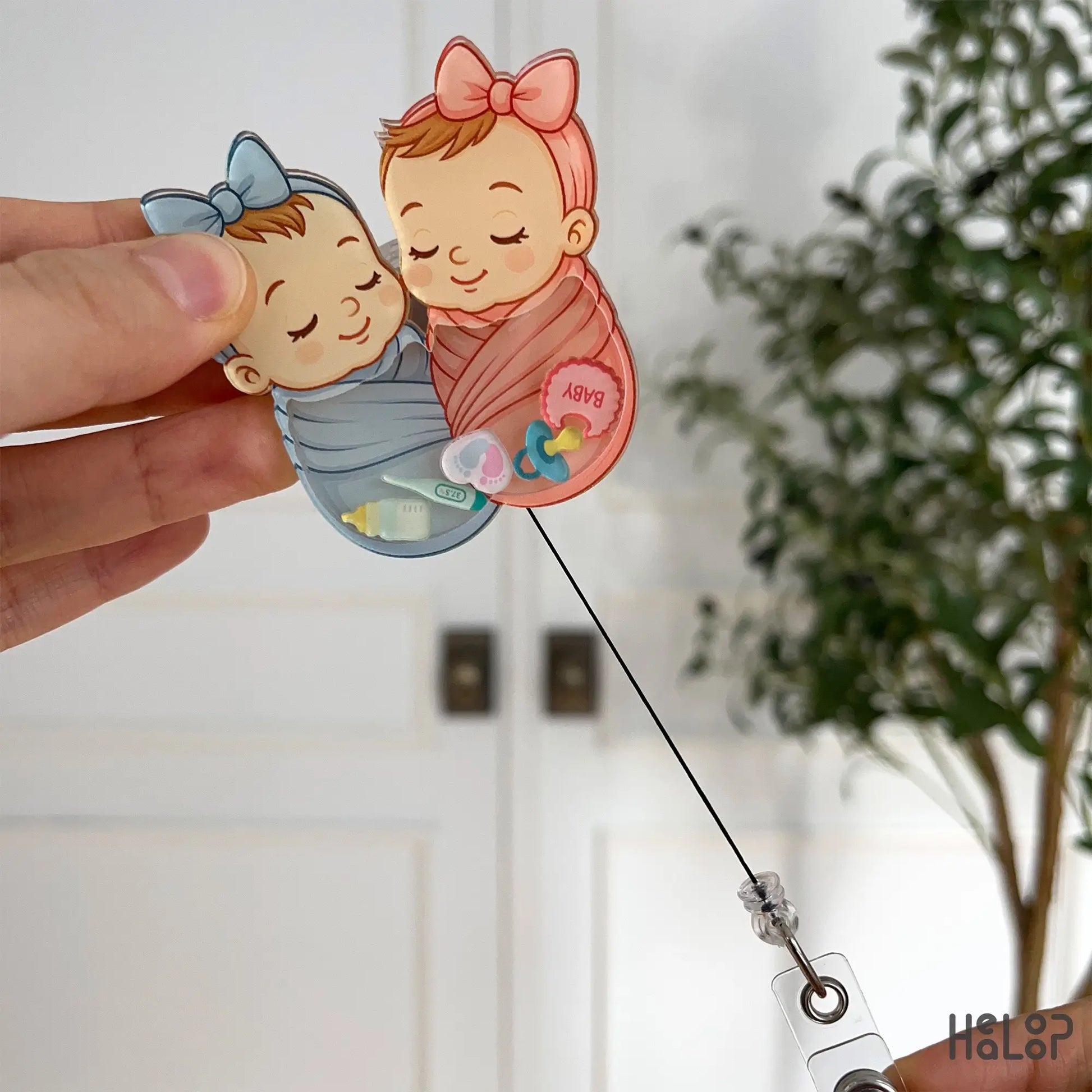 retractable swaddle baby badge reel featuring baby charms for nurses