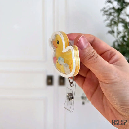 Side profile of rubber duck shaker badge reel showing layered acrylic badge holder