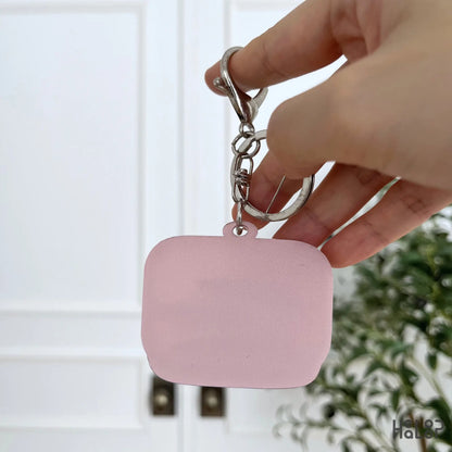 Back view of Sardine Shaker Keychain with smooth pink acrylic backing and silver keychain hardware.