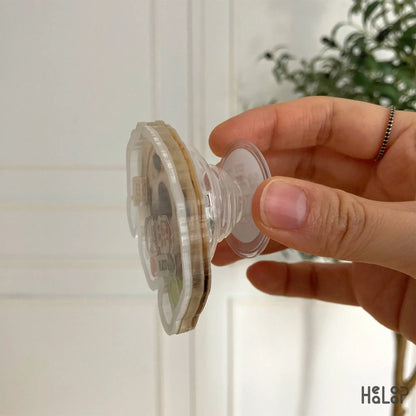 Side view of acrylic shaker phone grip showing layered 3D structure