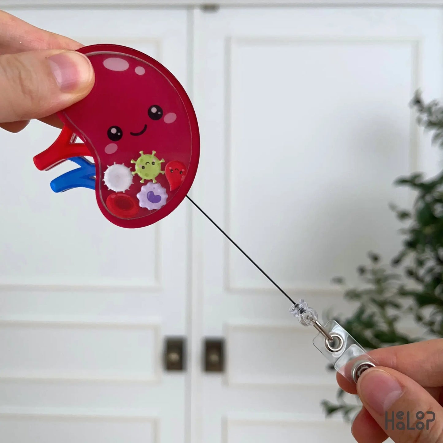 Spleen shaker badge reel with retractable cord demonstrating smooth extension for convenient daily badge access.