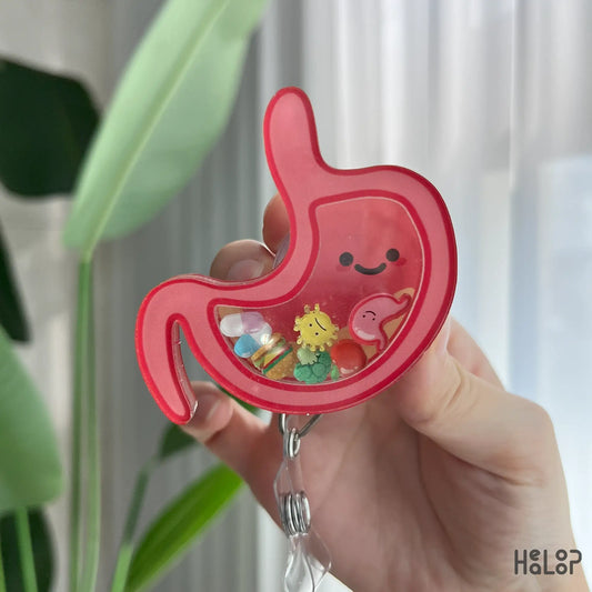 Cute stomach badge reel with acrylic shaker charms, held in hand, perfect for nurses and doctors