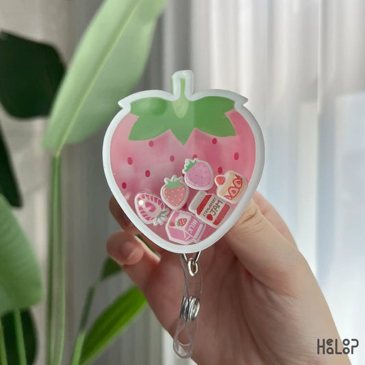 Detailed close-up of strawberry shaker badge reel with strawberry milk and jam charms