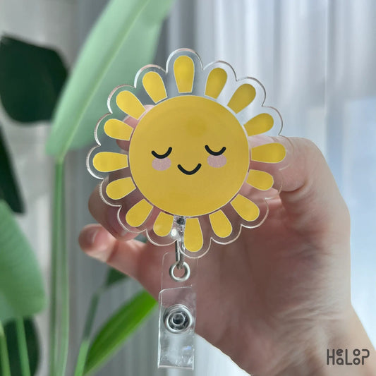 Bright yellow sunshine badge reel with smiling face, ideal for nurses and healthcare workers.