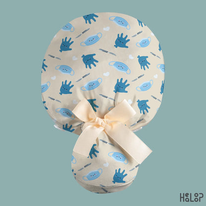 Surgical Ponytail Scrub Cap shown from the back, featuring cute blue surgical gloves, masks, scalpels, and white hearts on cream fabric with a cream ribbon bow and ponytail pouch.