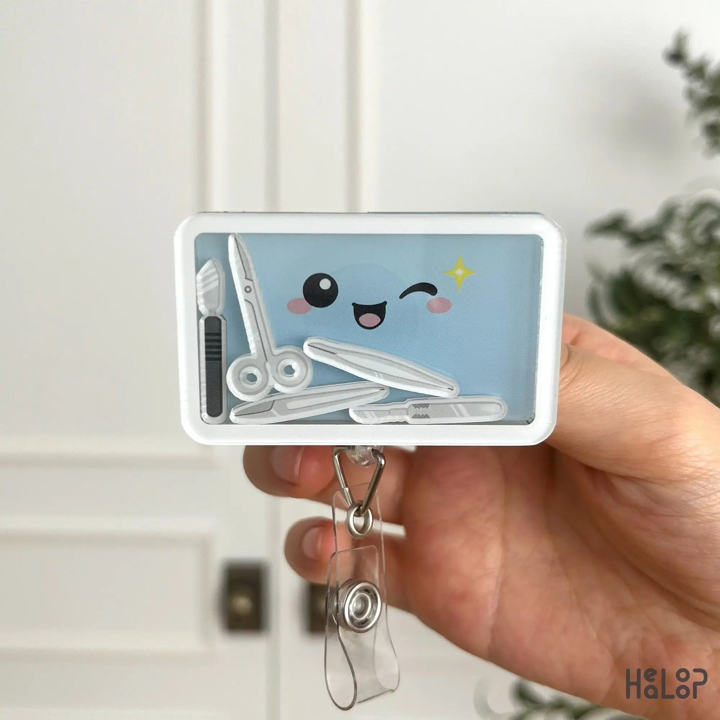 Surgical technologist shaker badge reel featuring surgical tray and operating room tools