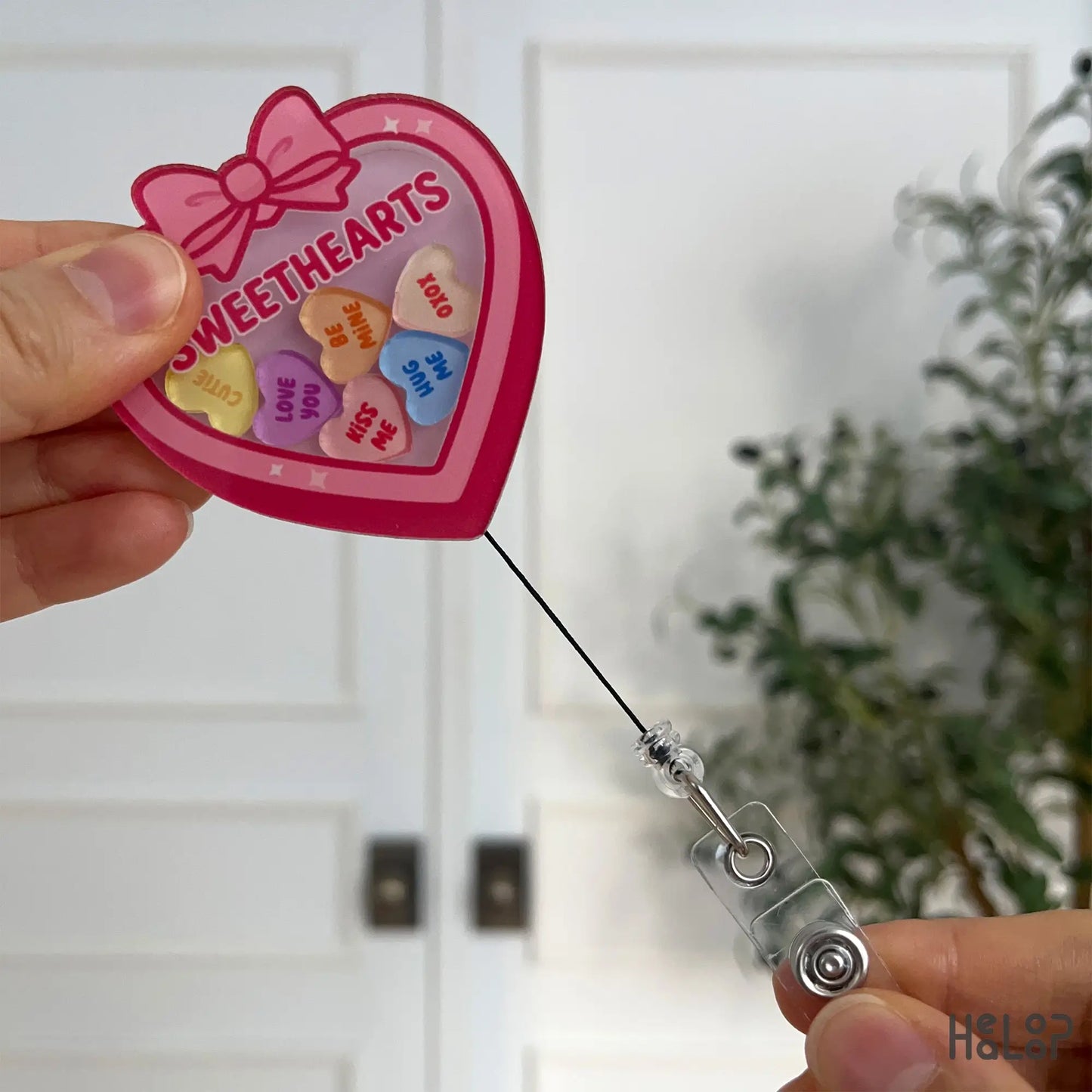 Retractable Sweethearts badge reel extended to show cord length and durability
