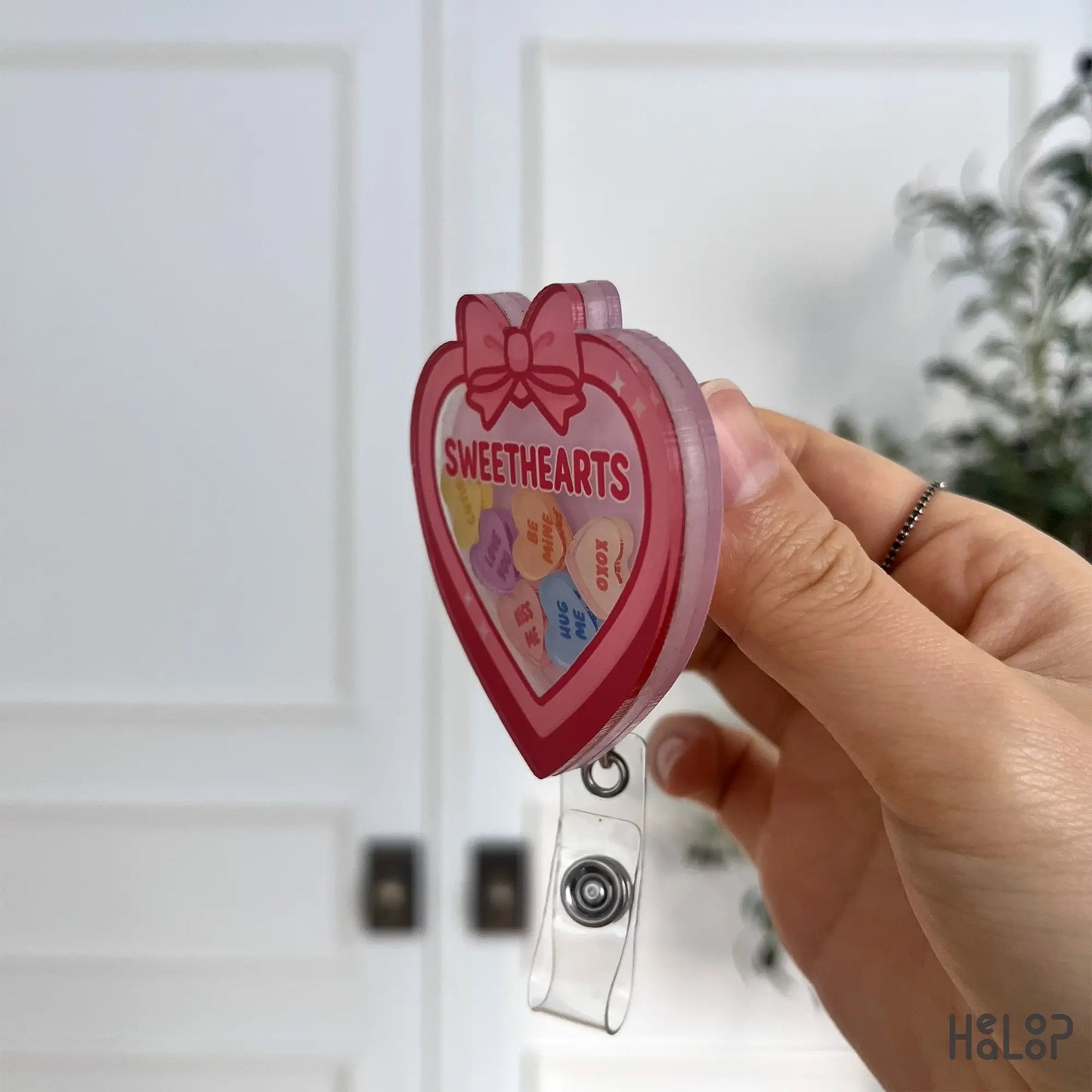 Side view of Sweethearts Valentine shaker badge reel with layered acrylic design