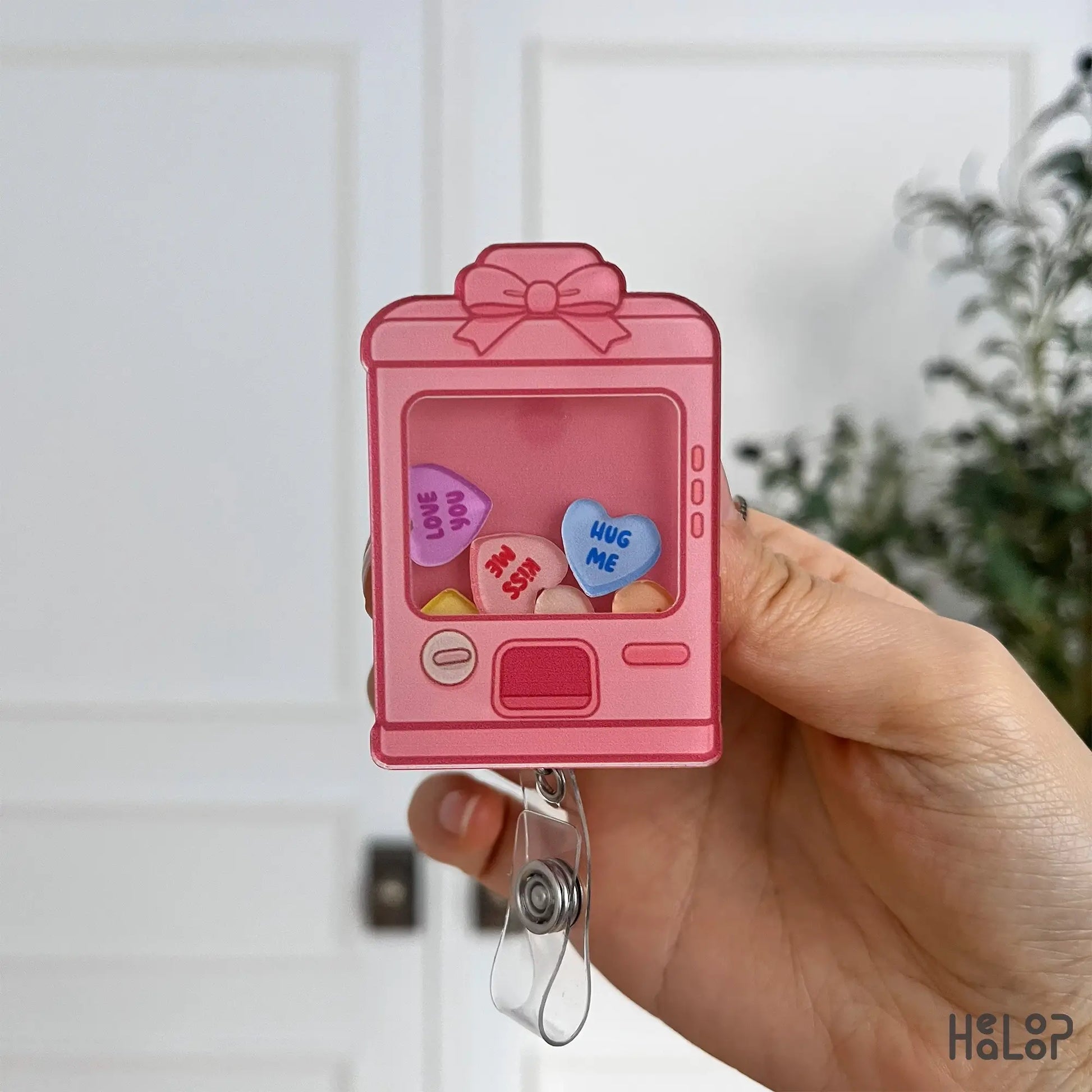 Detailed front view of Healoop Sweethearts vending machine shaker badge reel with candy hearts