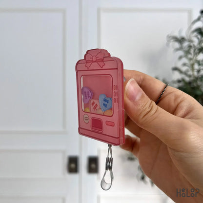 Side profile of Healoop Sweethearts vending machine shaker badge reel