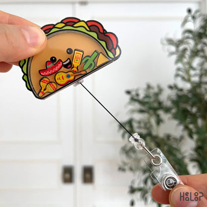 Retractable taco badge reel being pulled out