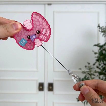 Healoop Thyroid Shaker Badge Reel demonstrating the retractable badge reel cord for convenient daily use.