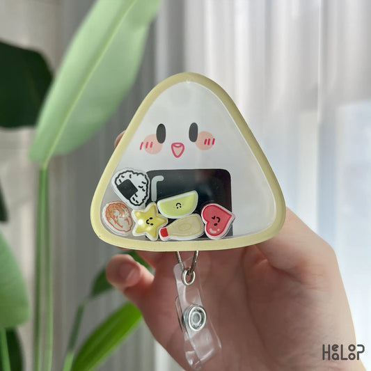 Closeup of cute triangular onigiri style nurse badge reel with shaker details