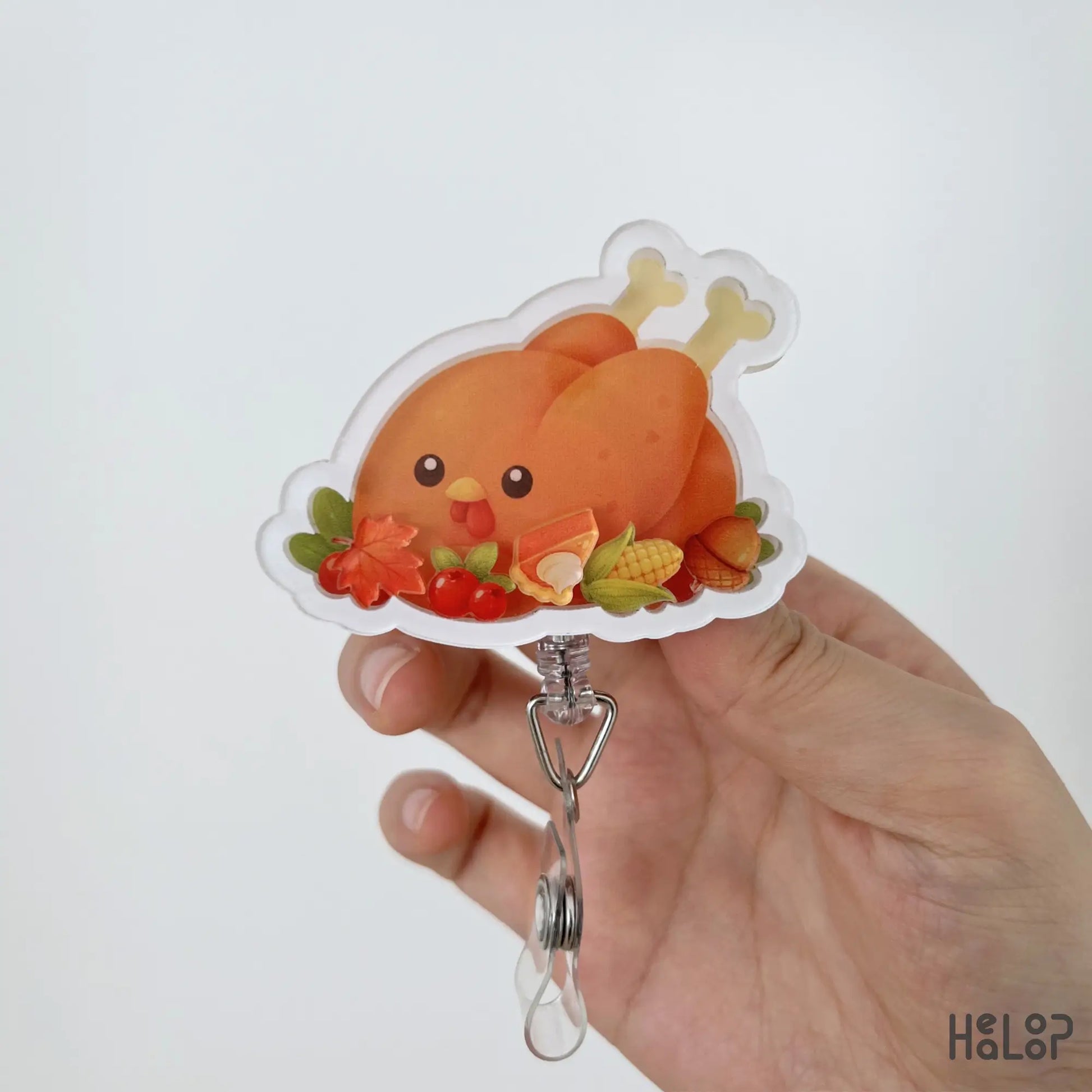 Close-up of Turkey Food Shaker Badge Reel featuring cute turkey, pumpkin pie, corn, cranberries, acorn, and autumn leaves