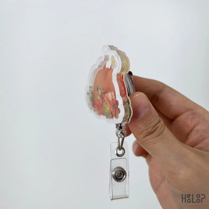 Side profile of layered acrylic Turkey Food Shaker Badge Reel with Thanksgiving-themed shaker pieces