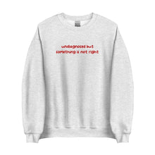 Ash-colored sweatshirt with 'undiagnosed but something is not right' embroidered in red, displayed flat for a detailed view.