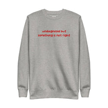 Carbon Grey sweatshirt with 'undiagnosed but something is not right' embroidered in red, displayed flat to showcase its design.