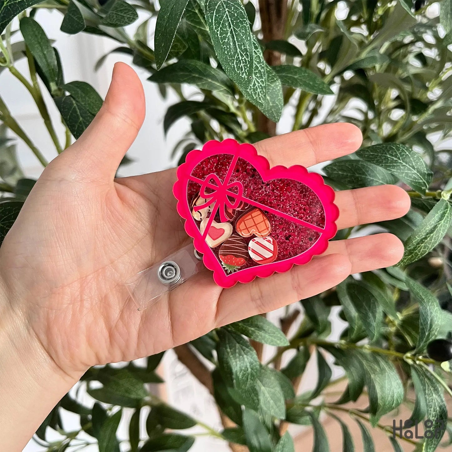 Heart chocolate box shaker badge reel featuring glitter and mini chocolate charms