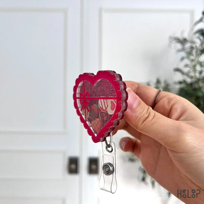 Side profile of pink heart-shaped chocolate shaker badge reel for nurses and healthcare workers