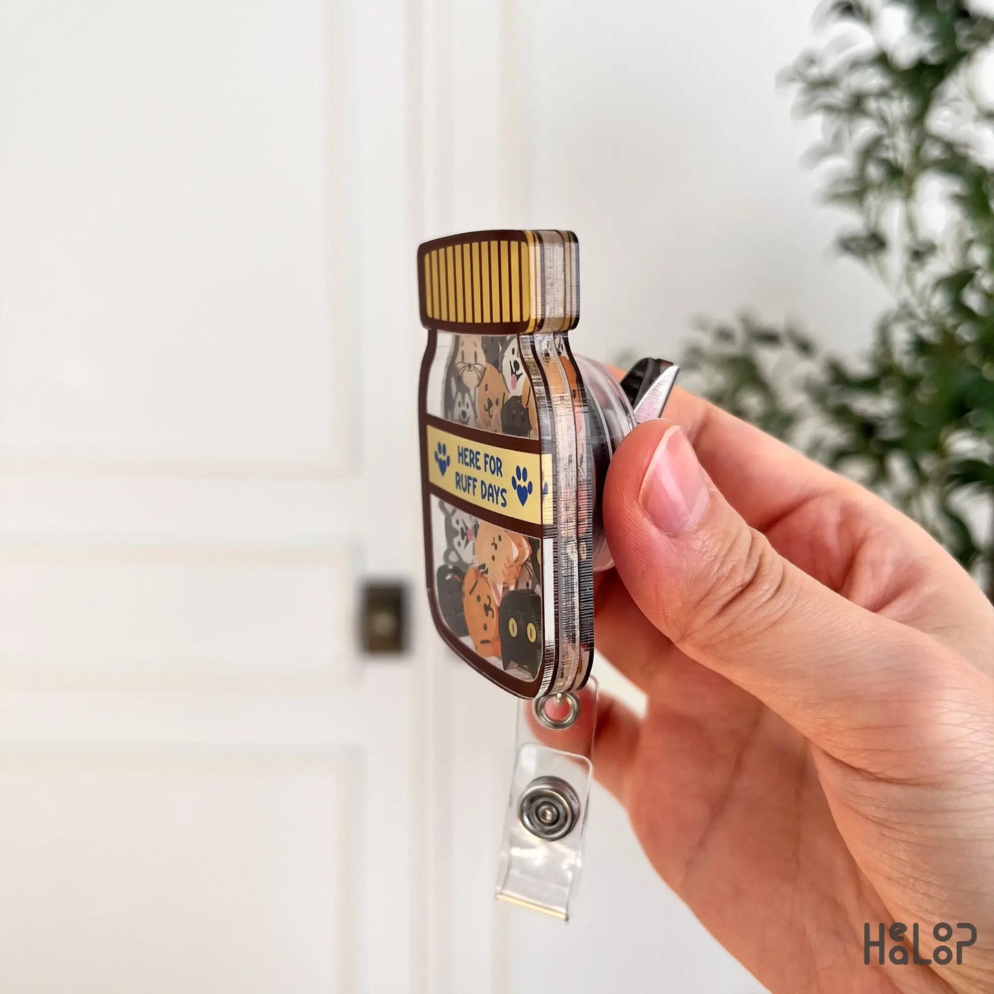 Side view of veterinary shaker badge reel showing acrylic layers and badge clip