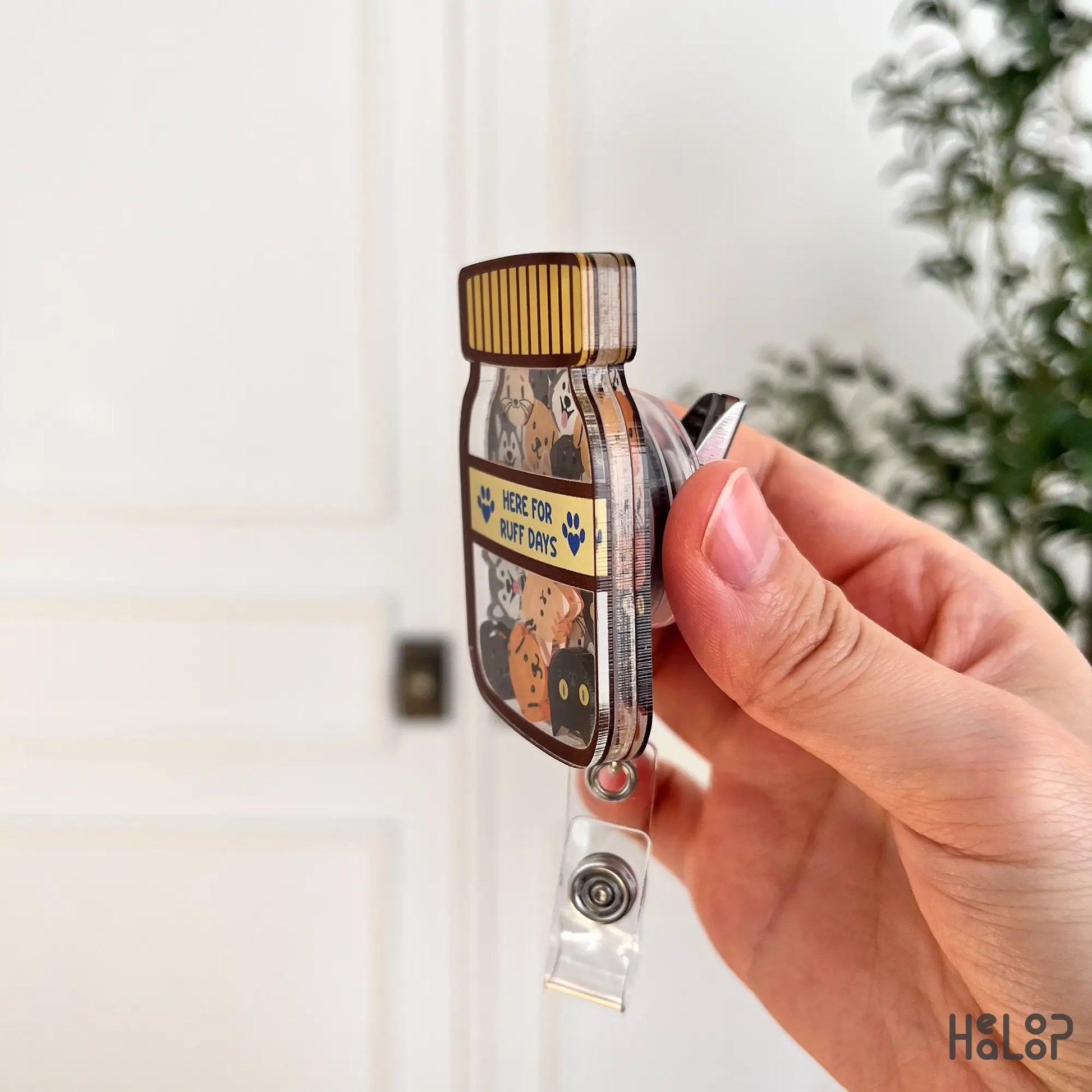 Side view of veterinary shaker badge reel showing acrylic layers and badge clip