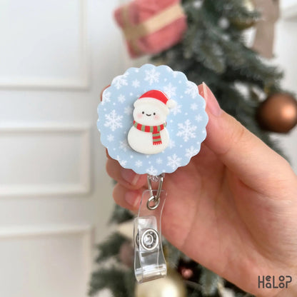 Winter Snowman Badge Reel with light blue snowflake pattern, cute seasonal ID holder for work