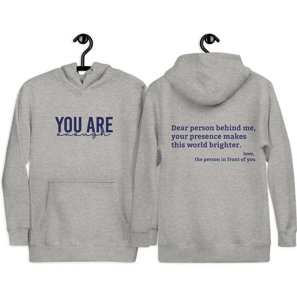 Carbon Grey hoodie with 'You are enough' embroidered in blue on the front and back print message 'Dear person behind me, your presence makes this world brighter,' emphasizing positivity and mental health.